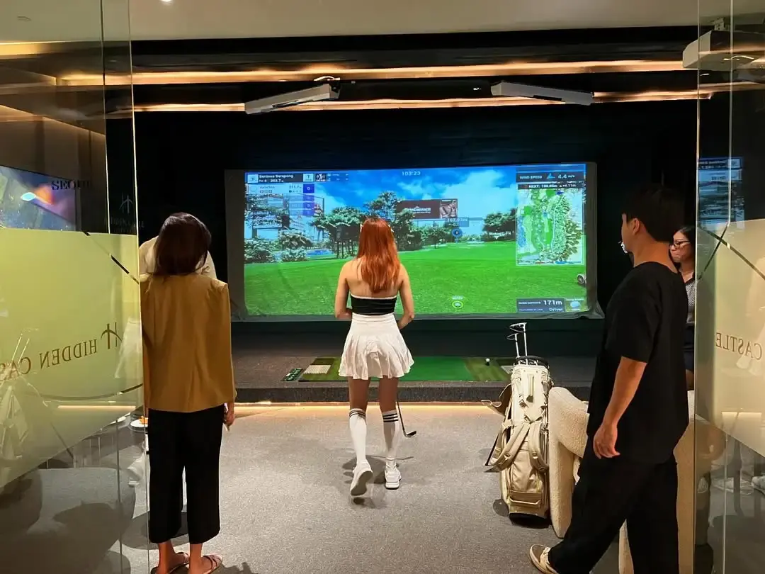 People enjoying a KGOLF simulator event at Hidden Castle Golf Club